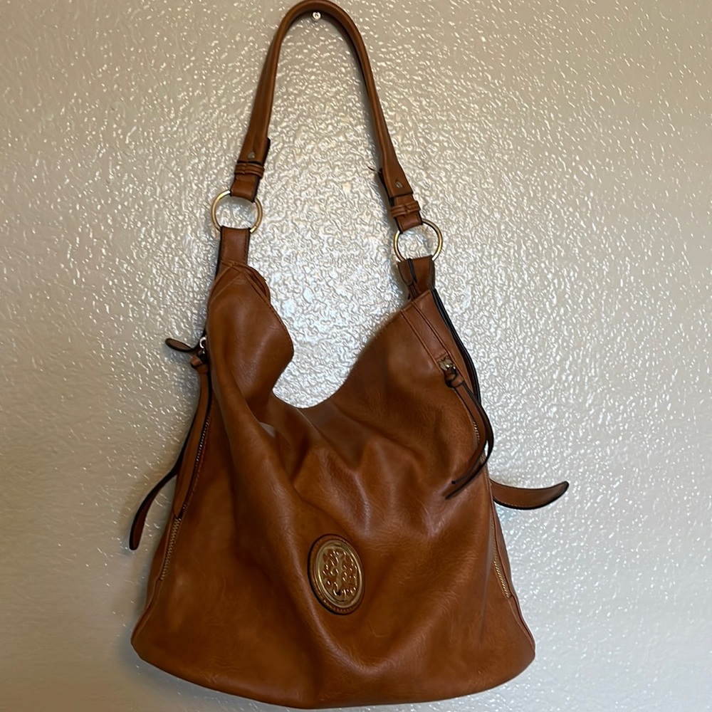 Large brown women’s purse with wrist wallet.